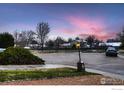 Peaceful neighborhood street view with mature trees and a charming lamp post at 2614 Denver Ave, Longmont, CO 80503