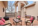 Enjoy outdoor living on this covered patio, featuring stone pillars and plenty of space for entertaining or relaxing at 2714 Calmante Pl, Superior, CO 80027