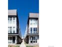 Modern townhome building with white siding, large windows, and well-maintained walkway at 3043 W 19Th Ave, Denver, CO 80204