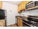 Efficient kitchen layout with stainless appliances, granite counters, and ample storage in light wood cabinetry at 3250 Oneal Cir # H17, Boulder, CO 80301