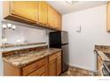 Updated kitchen featuring granite counters, stainless steel refrigerator, and lots of cabinets in the space at 3250 Oneal Cir # H17, Boulder, CO 80301