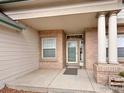 Inviting front porch with brick accents and classic columns at 412 E 131St Ave, Thornton, CO 80241
