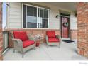 Inviting front porch with cozy seating, perfect for relaxing outdoors at 4426 Sidewinder Loop, Castle Rock, CO 80108