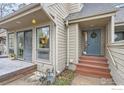 Welcome home to a cozy entrance with a charming blue door and warm wooden accents at 747 Meadow Glen Dr, Boulder, CO 80303