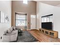 Spacious living room featuring a gray sofa, high ceilings, and ample natural light at 828 Kane Dr # 35, Longmont, CO 80501