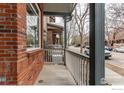 A side view of the porch showcases the brickwork, siding, and street in front of the house at 828 Kane Dr # 35, Longmont, CO 80501