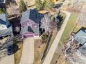 Aerial view of a suburban house with a long driveway and solar panels on the roof at 85 Kolar Ct, Erie, CO 80516