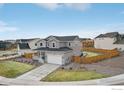 Attractive two-story home with a landscaped yard, a fenced backyard, and a two-car garage at 100 Stinson Pl, Castle Pines, CO 80108