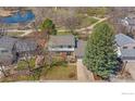 Aerial view of a charming home surrounded by beautiful trees and a well-kept lawn at 1449 Adams Pl, Louisville, CO 80027