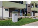 Modern home exterior with well-kept lawn and walkway at 1615 Harlan St # 2, Lakewood, CO 80214