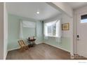 Bright living room boasting hardwood floors, large windows, and stylish decor at 1800 Vantage Pkwy, Berthoud, CO 80513