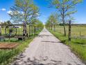 Gravel driveway lined with trees leading to the property, offering privacy at 2610 W County Road 4, Berthoud, CO 80513