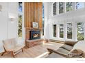 Cozy living room with wood burning fireplace, large windows, and comfortable seating at 287 Brook Cir, Boulder, CO 80302