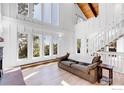 Bright living room with high ceilings, large windows, and hardwood floors at 287 Brook Cir, Boulder, CO 80302