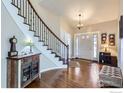 Inviting foyer featuring hardwood floors, curved staircase with iron railings, and stylish decor creating a warm welcome at 308 Elk Trl, Lafayette, CO 80026