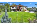Modern home with expansive lawn, mature trees, and sleek architectural design at 3633 Broadway St, Boulder, CO 80304