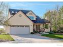 Charming two-story home featuring a well-maintained lawn, mature trees, and a two-car garage at 4462 Wellington Rd, Boulder, CO 80301
