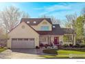 Inviting two-story home with a well-manicured front yard, covered porch and two car garage at 4462 Wellington Rd, Boulder, CO 80301