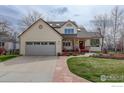Charming two-story home with a well-manicured lawn and inviting front porch at 4462 Wellington Rd, Boulder, CO 80301