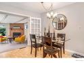 Elegant dining room features a glass table, chandelier, and view of the living room at 4560 Hanover Ave, Boulder, CO 80305