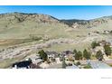 Aerial view of a home with solar panels and landscaping with mountain views at 4655 7Th St, Boulder, CO 80304