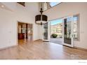 Bright living room with hardwood floors and doors to the stone patio with mountain views at 4655 7Th St, Boulder, CO 80304
