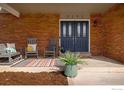 Inviting front porch with rocking chairs, brick facade, and stylish door at 5292 Lichen Pl, Boulder, CO 80301