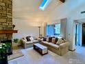 Bright living room featuring a stone fireplace, skylight, and sliding glass door at 6239 Willow Ln, Boulder, CO 80301