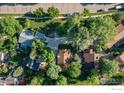 Birds-eye view of the property with surrounding residences and lush trees shading a peaceful neighborhood at 6396 Twin Lakes Rd, Boulder, CO 80301