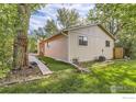 Backyard view showing the home's exterior, landscaping, and green space at 6396 Twin Lakes Rd, Boulder, CO 80301