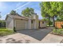 Attractive home exterior with a garage, a chimney, and a lush lawn at 6396 Twin Lakes Rd, Boulder, CO 80301
