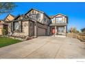 Charming two-story home featuring a manicured lawn and a long driveway at 6433 Eagle Butte Ave, Frederick, CO 80516