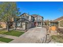Charming two-story home featuring a manicured lawn and a long driveway at 6433 Eagle Butte Ave, Frederick, CO 80516