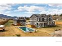 Aerial view of home with a pool, spacious yard, detached garage, and beautiful landscape at 6685 Baseline Rd, Boulder, CO 80303