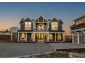 Inviting two-story home featuring large windows, white trim, and a covered front porch at 6685 Baseline Rd, Boulder, CO 80303