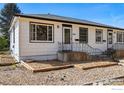 Charming home with updated landscaping, a cozy porch, and clearly visible house number at 809 Sunset St, Longmont, CO 80501