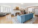 Inviting living room with fireplace, blue sofa, hardwood floors, and connected to other rooms at 861 13Th St, Boulder, CO 80302