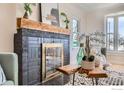 Close up of fireplace featuring striking hearth, wooden mantle, and decor accents at 865 Holly St, Denver, CO 80220
