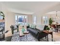 Cozy living room featuring a bay window, hardwood floors, and modern decor at 865 Holly St, Denver, CO 80220