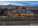 Expansive backyard featuring a covered patio, pool, and mountain views, perfect for outdoor entertaining at 8852 Portico Ln, Longmont, CO 80503