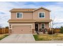 Inviting two-story house featuring a spacious driveway, stone accents, and a cozy front porch seating area at 1022 Wagon Bend Rd, Berthoud, CO 80513