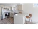 Stylish kitchen features quartz countertops, stainless steel appliances, and breakfast bar at 1085 Fairway Ct # A, Boulder, CO 80303