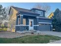 Charming two-story home with a well-manicured lawn and a two-car garage at 13874 Adams Cir, Thornton, CO 80602