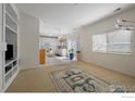 Open-concept living room with lots of natural light and a view of the kitchen at 13874 Adams Cir, Thornton, CO 80602
