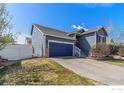 A charming home with a well-kept lawn, driveway, and garage, all beautifully bathed in natural light at 16282 Ginger Ave, Mead, CO 80542