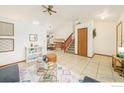 Open concept living room leading to the dining area and staircase with tile flooring at 1731 Sumner St, Longmont, CO 80501
