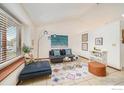 Bright living room with vaulted ceiling, large window, and stylish modern decor at 1731 Sumner St, Longmont, CO 80501