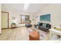 Inviting living room with tile floors, modern furnishings, and lots of natural light at 1731 Sumner St, Longmont, CO 80501