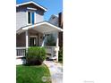 View of a lovely, covered front porch with stone pathway, and well-kept lawn at 1835 Columbine Ave, Boulder, CO 80302