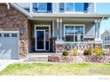 Inviting home exterior with brick accents and a cozy front porch at 1867 W 131St Ln, Denver, CO 80234